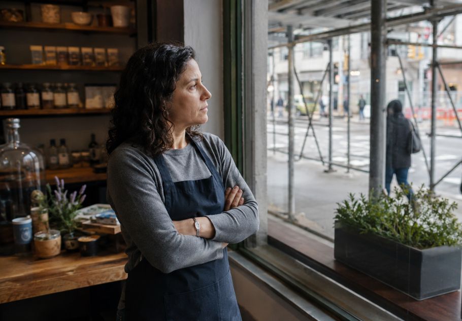 Concerned NYC shop owner behind scaffolding